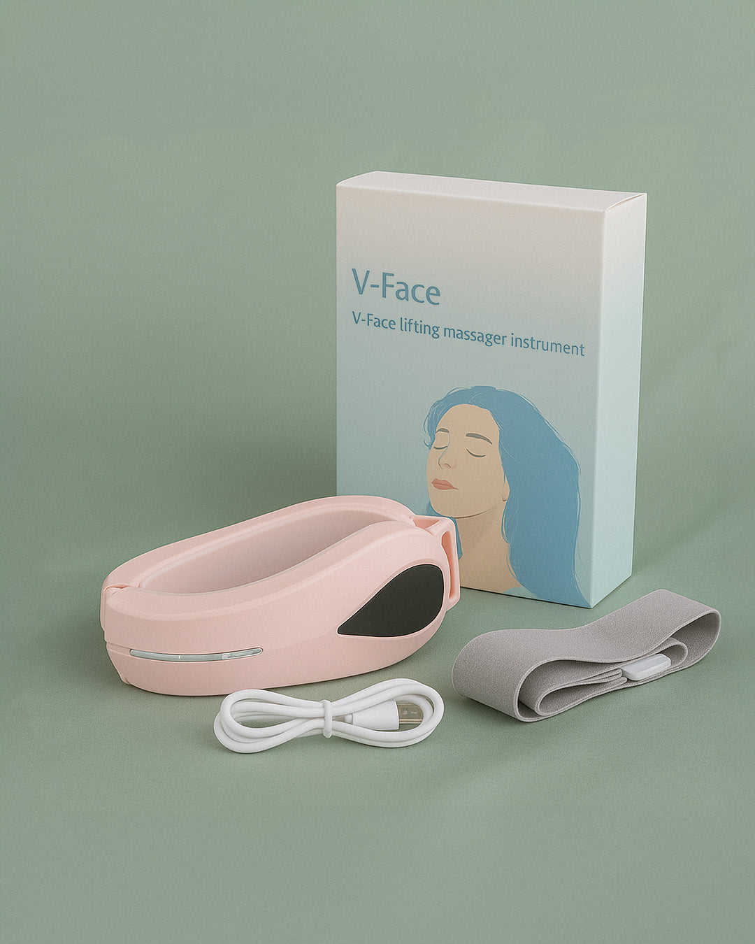 Pink V-Face lifting massager instrument with packaging and cable on a green background