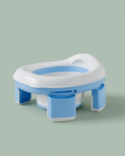 Blue and white potty seat on a light green background