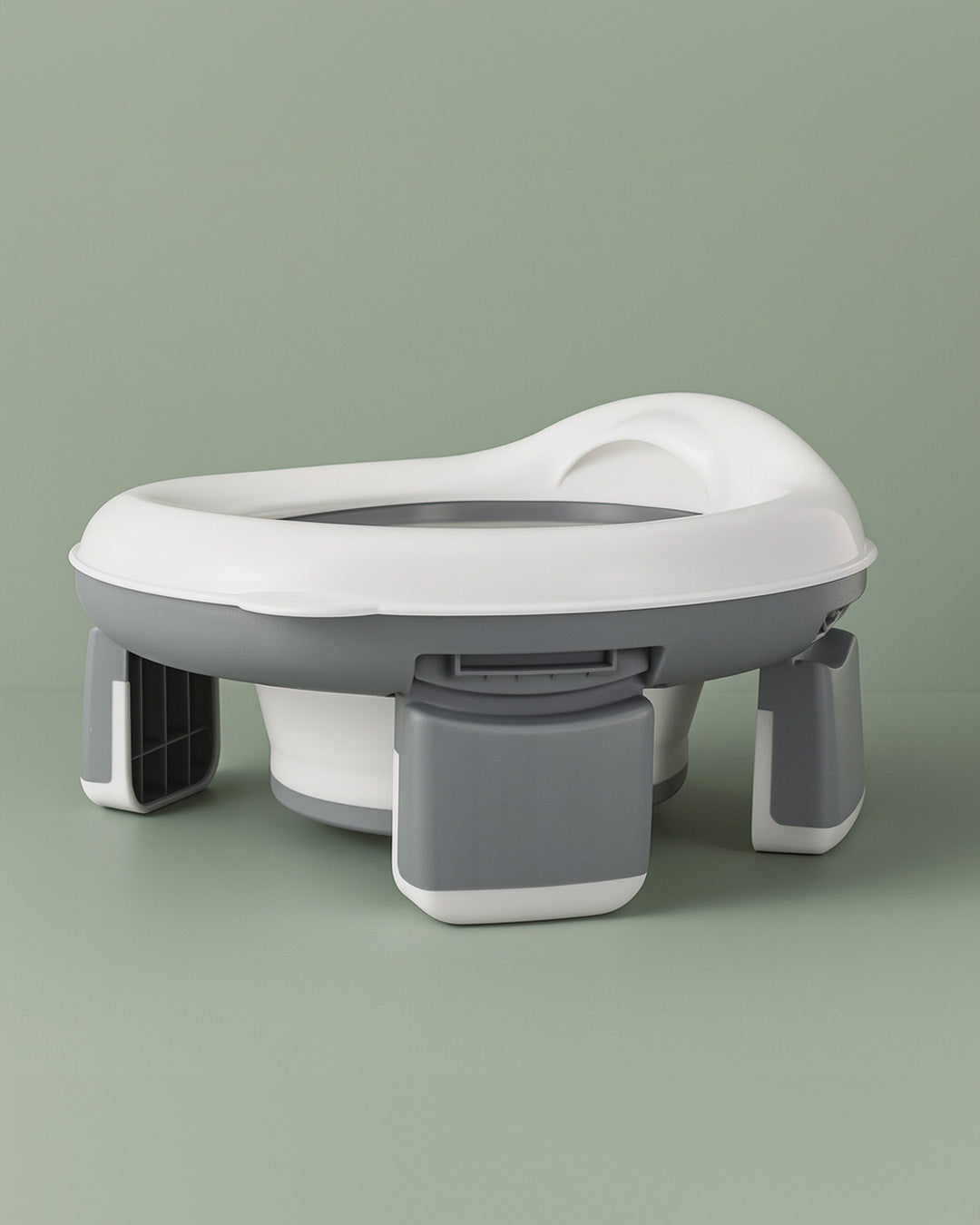 White and grey potty seat on a green background
