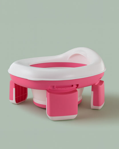 Pink and white plastic potty seat with stand on a light green background