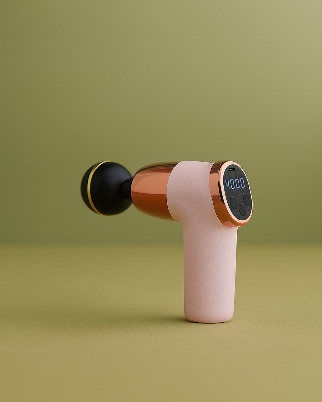 Pink and black handheld massager on a green background