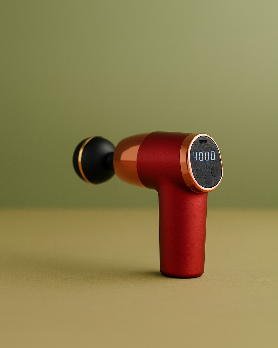 Red massage gun with digital display on a green background