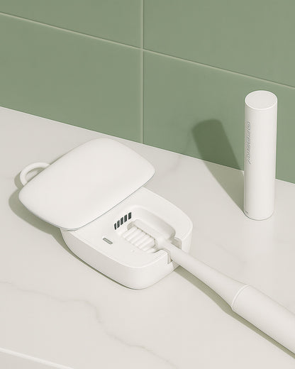 White toothbrush with UV sterilisier on a light surface against a green tiled wall.