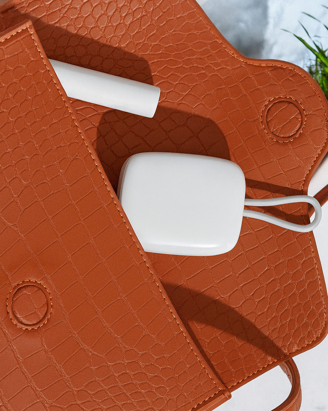 White Portable Toothbrush UV Steriliser with a cable inside a brown textured bag.