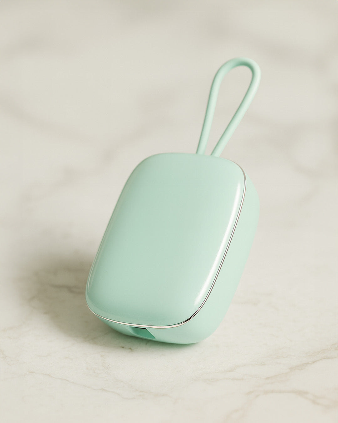 Mint green Portable Toothbrush UV Steriliser with a strap on a light beige background