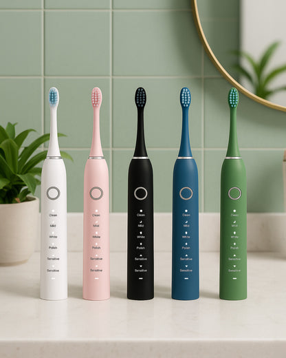 Five different coloured electric sonic toothbrushes sitting on a light bathroom stone counter with sage tiles and mirror