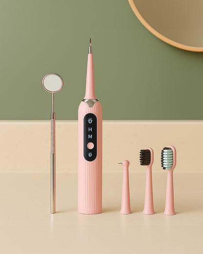 Pink dental tool set with multiple components on a beige surface against a green wall.