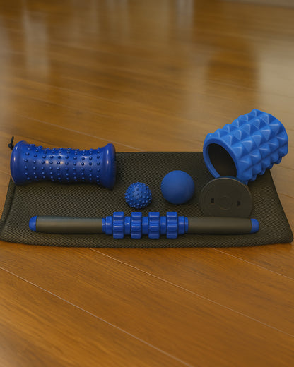 Foam roller set with massage ball on a mat on a wooden floor
