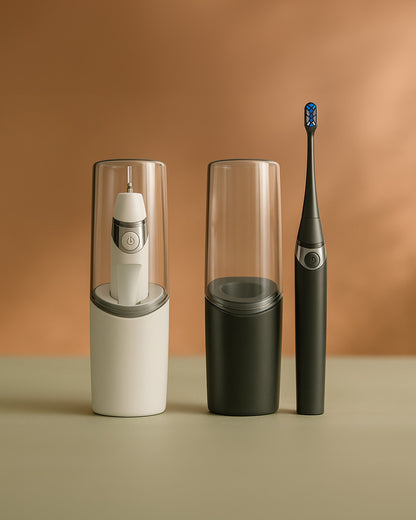 White and Black Travel Electric Rechargeable Toothbrush next to its charging case on a beige surface with a brown background